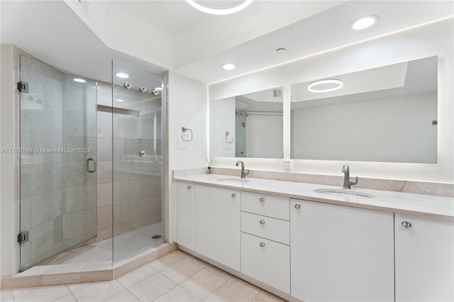 bathroom featuring vanity, tile patterned floors, and a shower with door