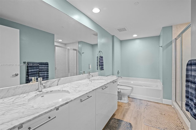 full bathroom featuring toilet, vanity, shower with separate bathtub, and hardwood / wood-style flooring