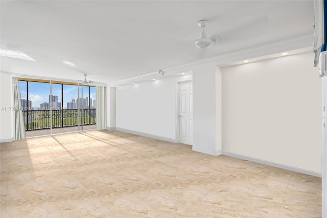 empty room with floor to ceiling windows and crown molding