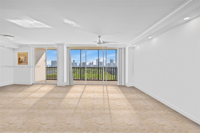 empty room with ceiling fan and crown molding