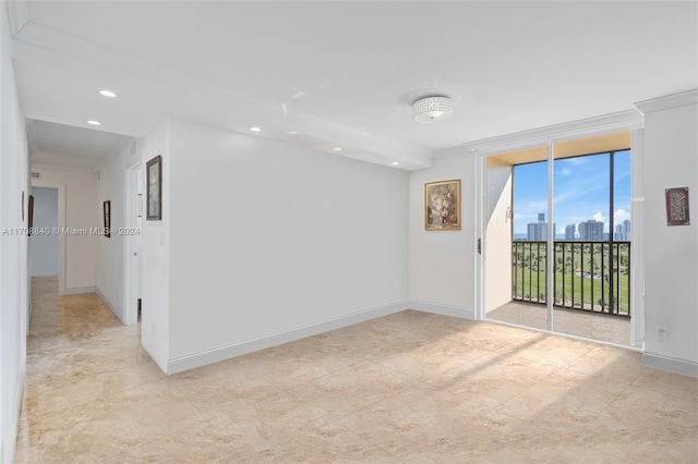 spare room featuring crown molding