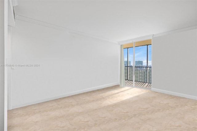 spare room with floor to ceiling windows and ornamental molding