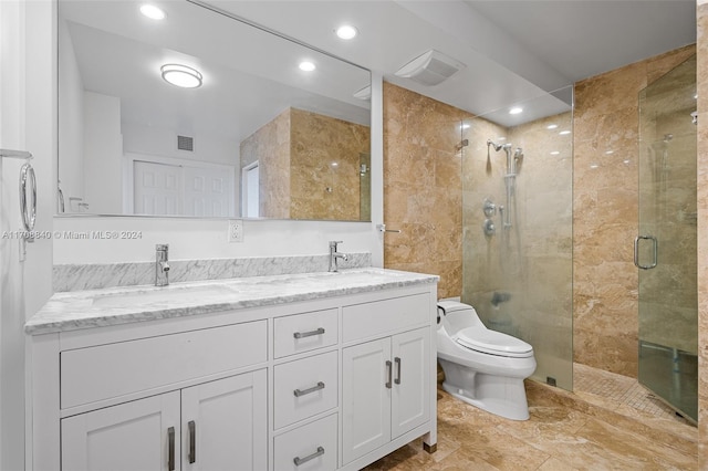 bathroom featuring vanity, toilet, and an enclosed shower