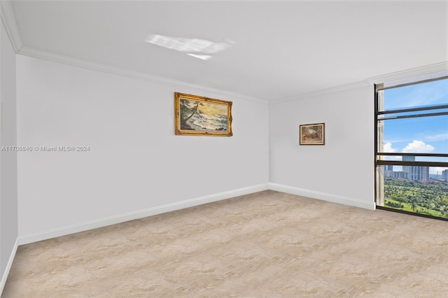 empty room featuring a wall of windows and ornamental molding