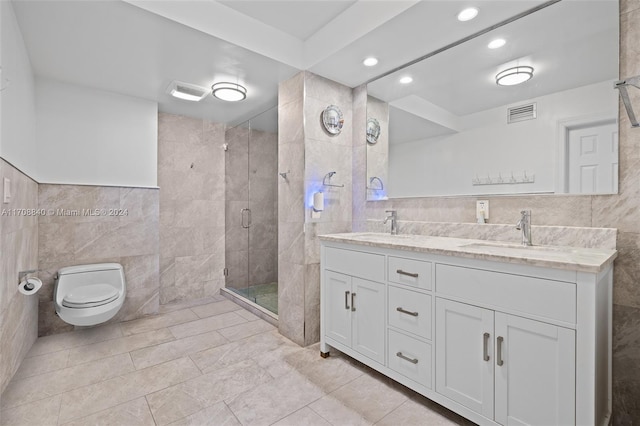 bathroom with toilet, an enclosed shower, tile walls, and vanity