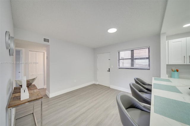 office area featuring a textured ceiling and light wood-type flooring