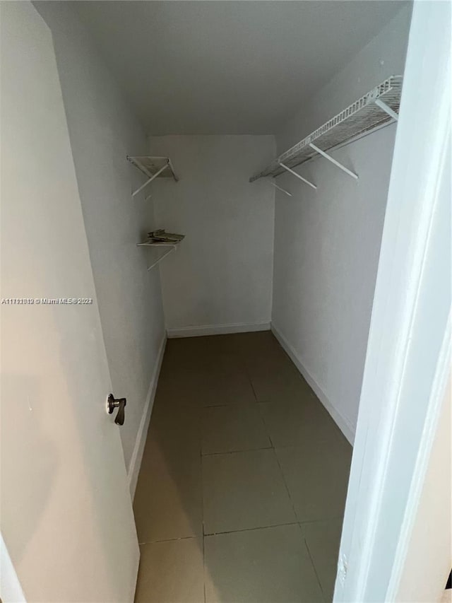 spacious closet featuring tile patterned flooring