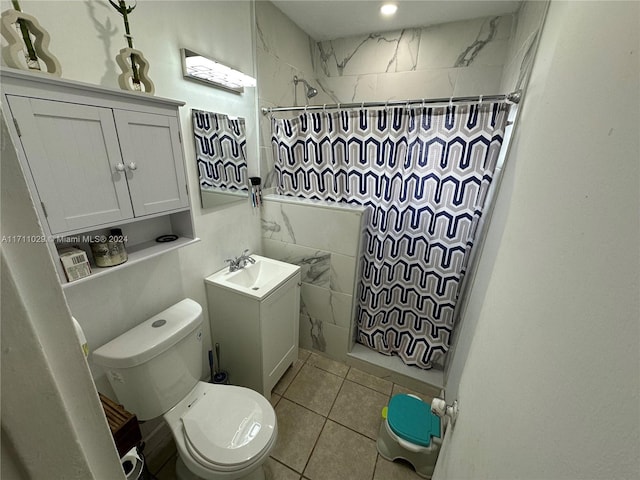 bathroom featuring tile patterned floors, vanity, toilet, and walk in shower