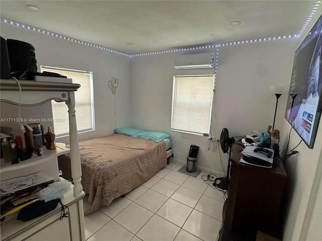 bedroom featuring a wall unit AC and light tile patterned flooring