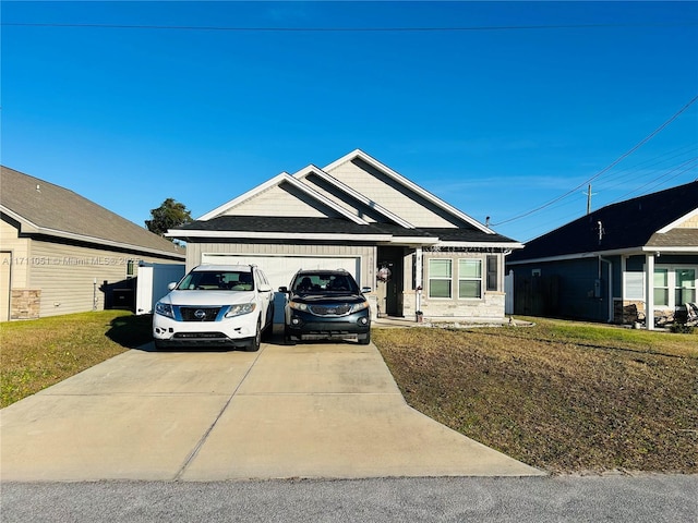 view of front of property featuring a front lawn and a garage