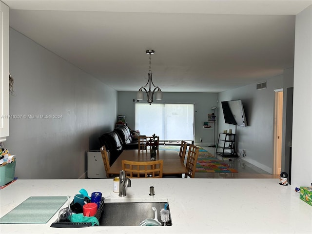 kitchen with hanging light fixtures and a notable chandelier