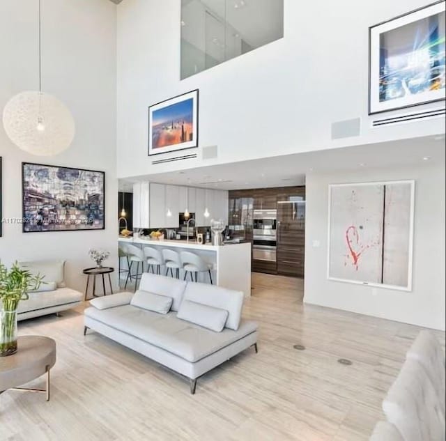 living room featuring a towering ceiling