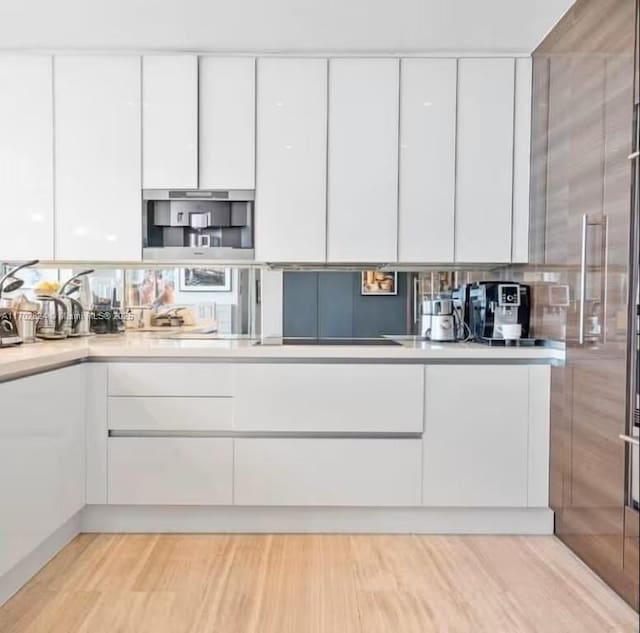 kitchen featuring white cabinets and light hardwood / wood-style floors