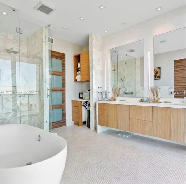 bathroom featuring vanity and shower with separate bathtub