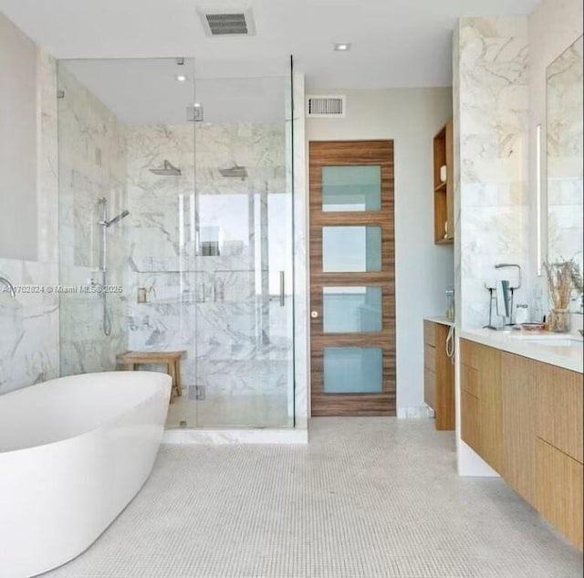 bathroom featuring tile patterned floors, vanity, and separate shower and tub