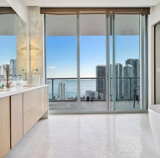 bathroom featuring a tub to relax in, a wealth of natural light, and vanity