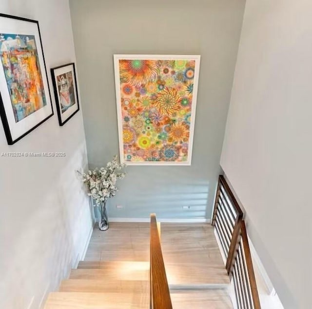 staircase featuring wood-type flooring