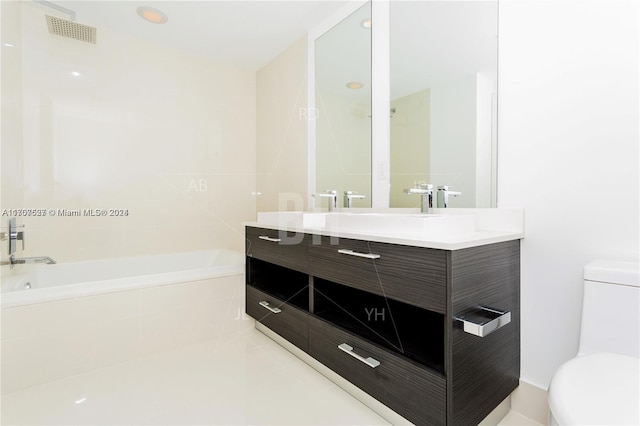 bathroom with tiled bath, vanity, and toilet