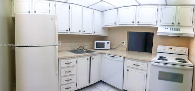 kitchen with white appliances, exhaust hood, sink, light tile patterned flooring, and white cabinetry