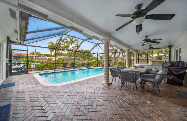 view of swimming pool with a grill, a lanai, and a patio