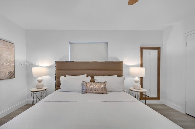 bedroom with dark hardwood / wood-style floors and ceiling fan