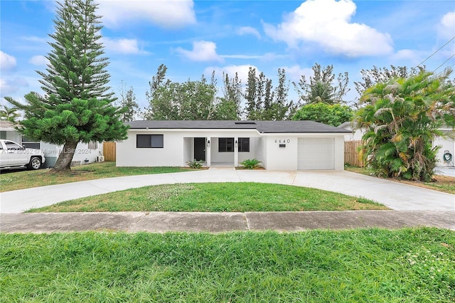 single story home featuring a front yard and a garage