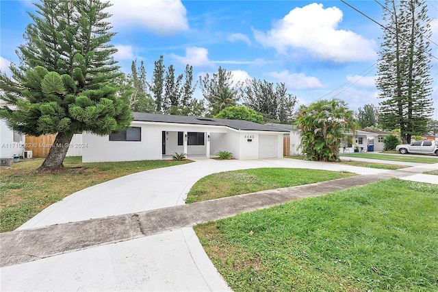 single story home featuring a garage and a front lawn