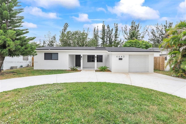 ranch-style house with a front lawn and a garage