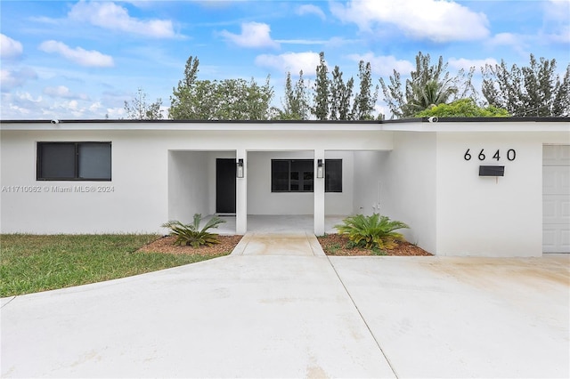 doorway to property featuring a garage and covered porch