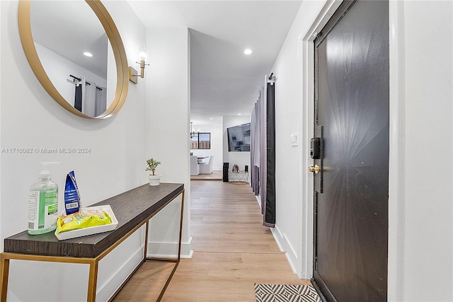 hall with light hardwood / wood-style flooring