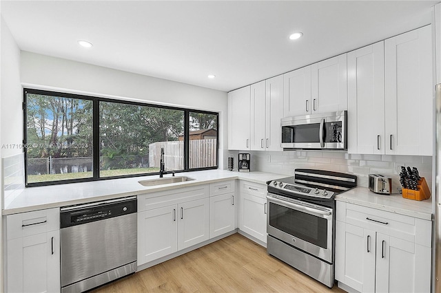 kitchen featuring white cabinetry, sink, and appliances with stainless steel finishes