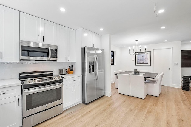 kitchen featuring white cabinetry, light wood-type flooring, and appliances with stainless steel finishes