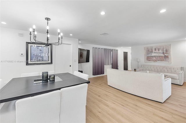 interior space featuring a notable chandelier and light hardwood / wood-style flooring