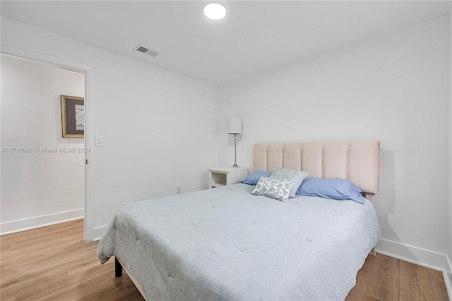 bedroom with hardwood / wood-style flooring