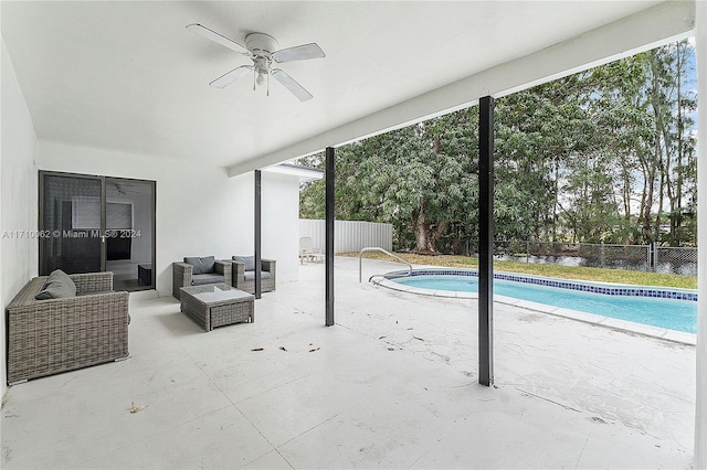 view of pool with an outdoor living space and ceiling fan