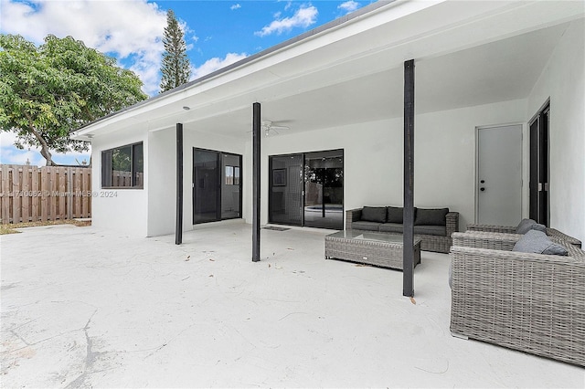 back of property featuring an outdoor living space, a patio, and ceiling fan