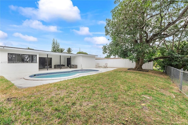 exterior space with a fenced in pool and a patio