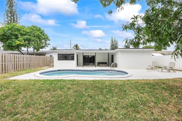 view of swimming pool featuring a yard and a patio