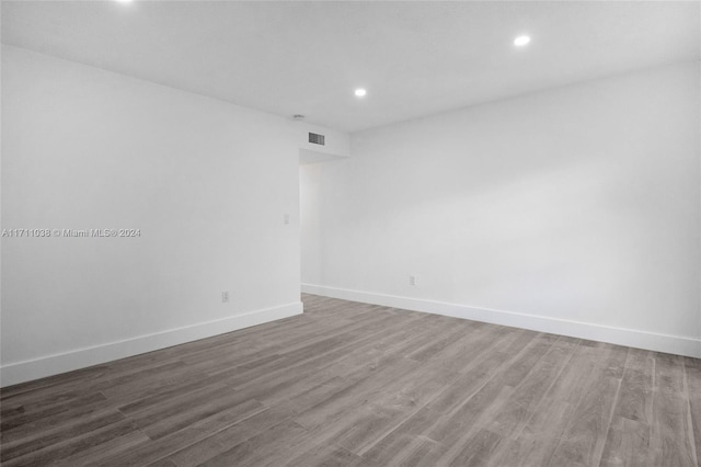 empty room with dark hardwood / wood-style flooring