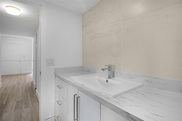 bathroom with hardwood / wood-style floors and vanity