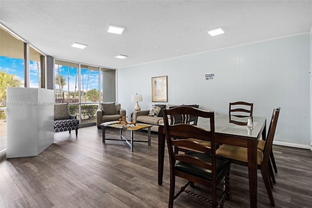 dining space featuring a textured ceiling, crown molding, floor to ceiling windows, and dark wood-type flooring