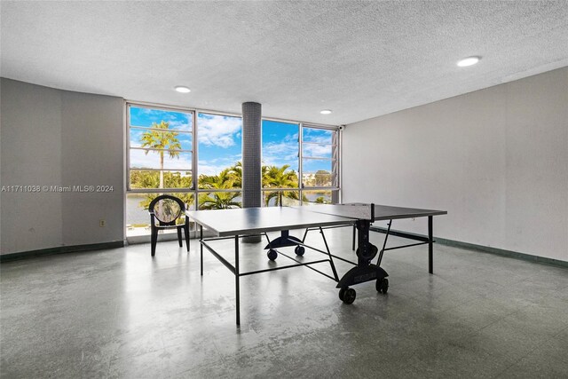 rec room featuring expansive windows and a textured ceiling