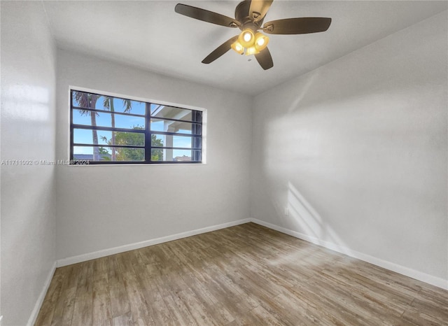 empty room with ceiling fan and hardwood / wood-style floors