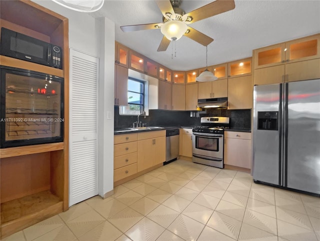 kitchen with ceiling fan, sink, stainless steel appliances, tasteful backsplash, and pendant lighting