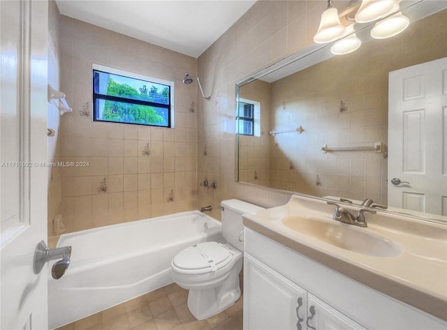 full bathroom featuring tile patterned flooring, plenty of natural light, toilet, and tiled shower / bath