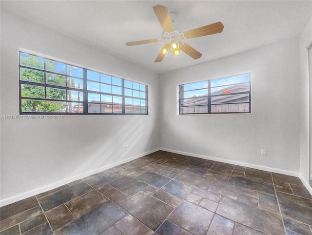 spare room with ceiling fan