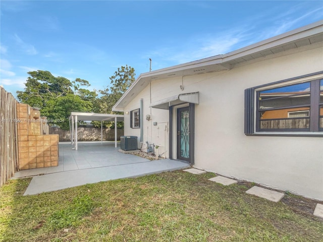 exterior space with central air condition unit and a patio