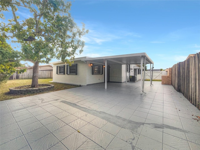 rear view of house with a patio area and central AC unit