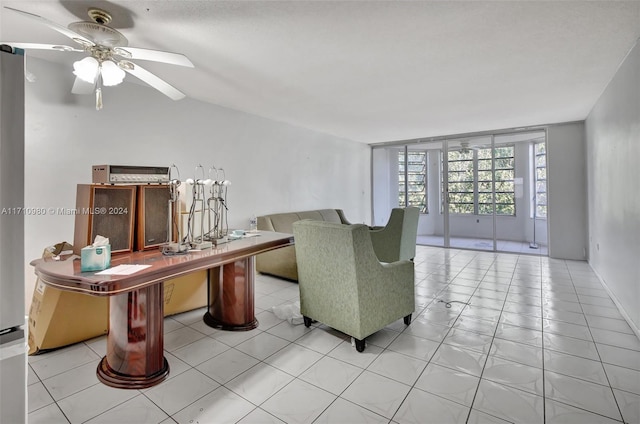 living room with ceiling fan and light tile patterned floors