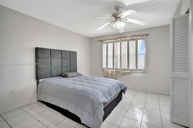 bedroom with ceiling fan and light tile patterned floors